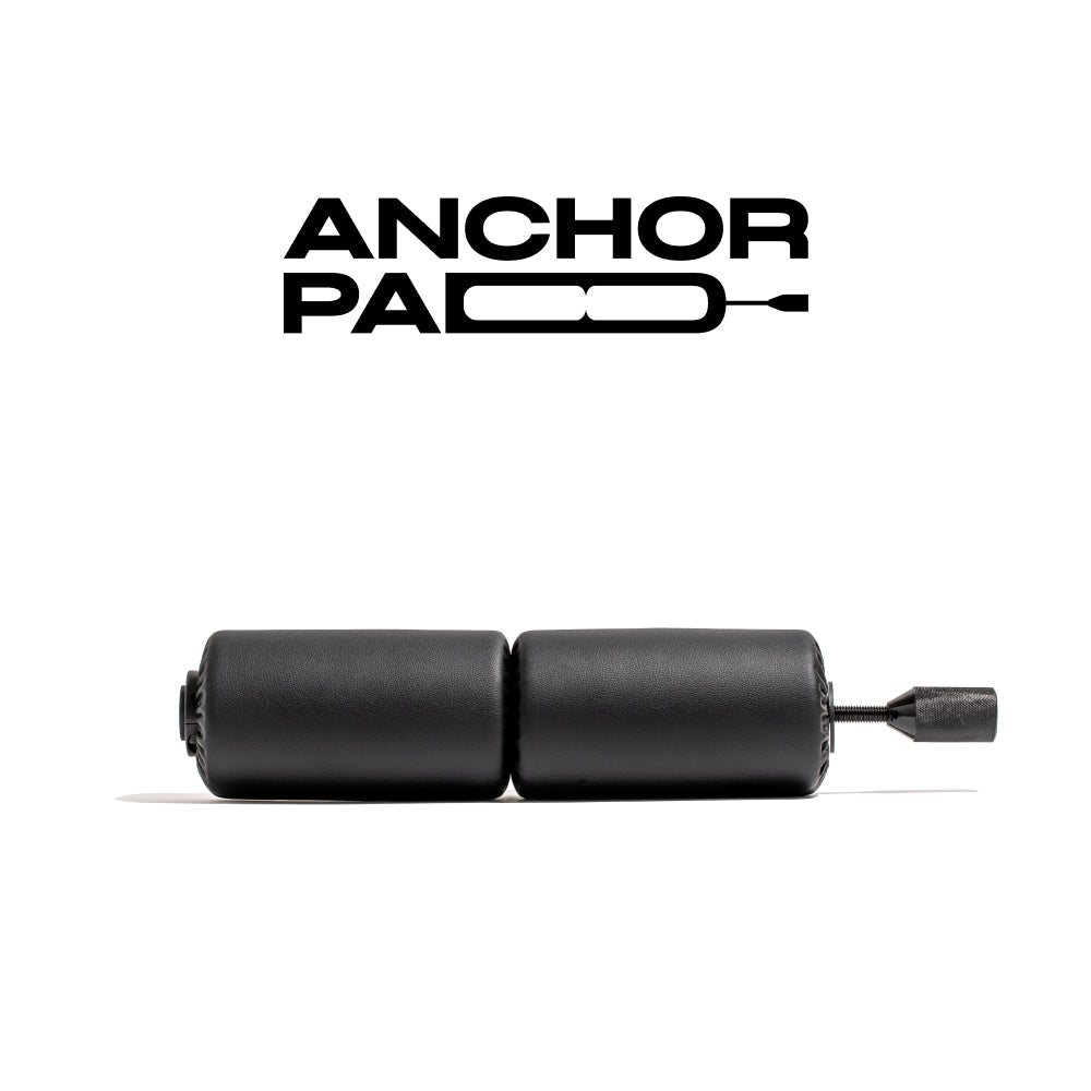 Anchor Pads product image featuring two cylindrical black pads connected by a metal screw. The product is displayed with the Anchor logo in the background.