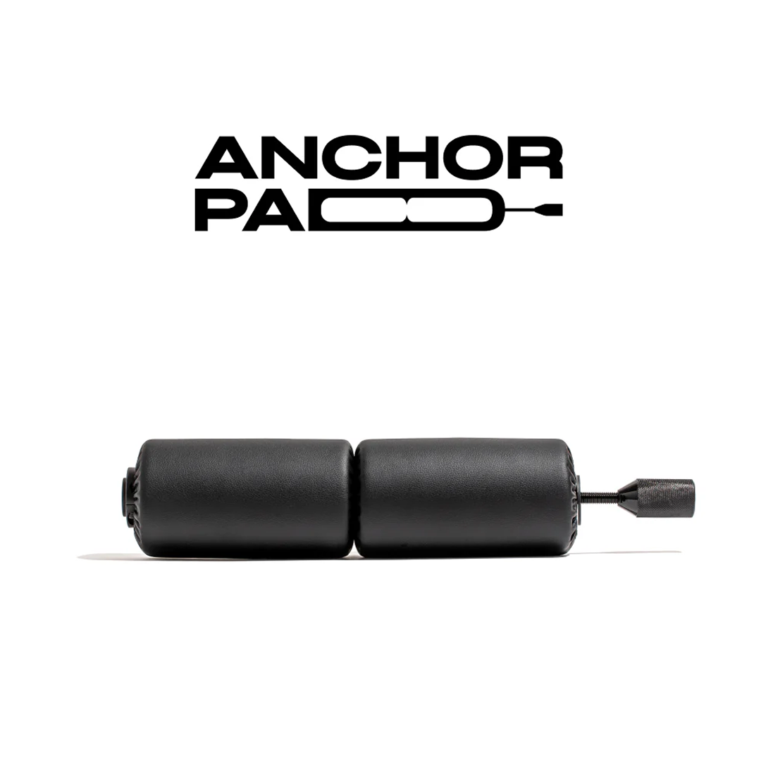 Anchor Pads product image featuring two cylindrical black pads connected by a metal screw. The product is displayed with the Anchor logo in the background.